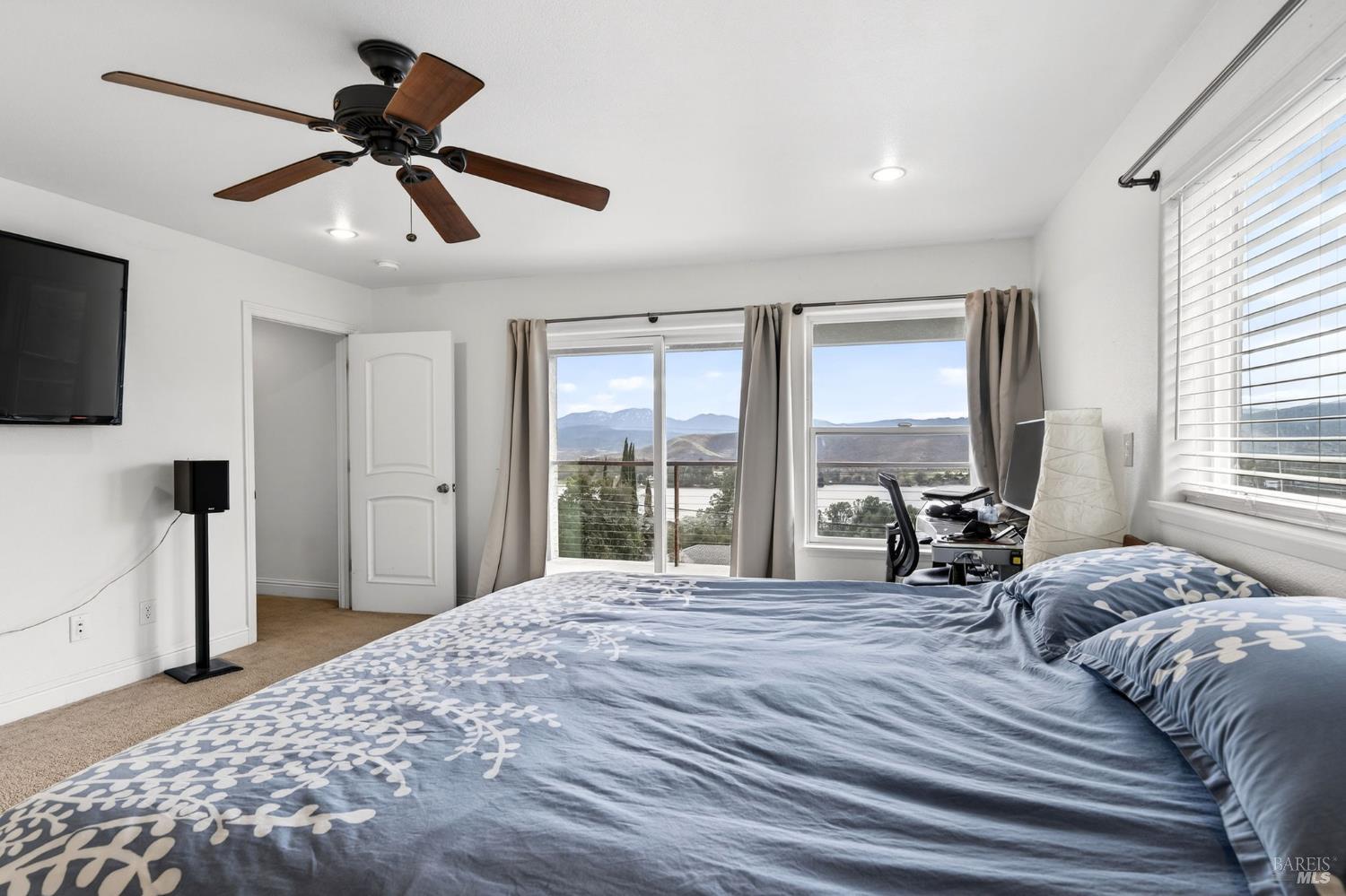 17437 Greenridge Road Hidden Valley Lake, CA 95467 - Photo 7 of 54 a view of a bedroom with a bed and a large window