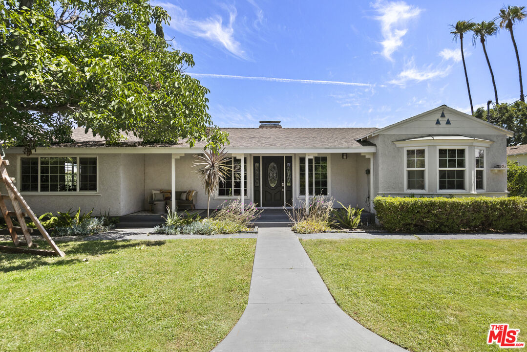 a front view of house with yard and outdoor seating