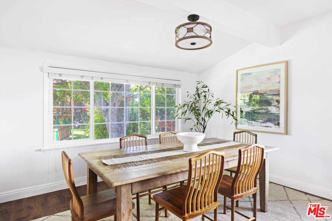 13604 Hart Street Van Nuys, CA 91405 - Photo 12 of 43 a dining room with furniture a rug and a large window