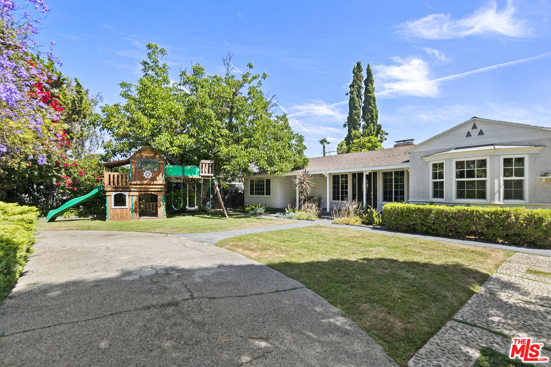 13604 Hart Street Van Nuys, CA 91405 - Photo 2 of 43 a front view of a house with a garden