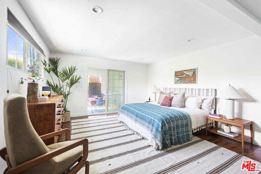 13604 Hart Street Van Nuys, CA 91405 - Photo 24 of 43 a bedroom with a bed wooden floor and window