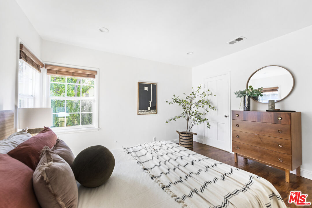 13604 Hart Street Van Nuys, CA 91405 - Photo 27 of 43 a bedroom with a bed and dresser with mirror