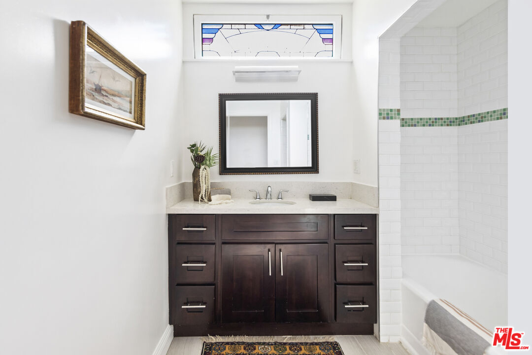 13604 Hart Street Van Nuys, CA 91405 - Photo 28 of 43 a bathroom with a sink and a mirror