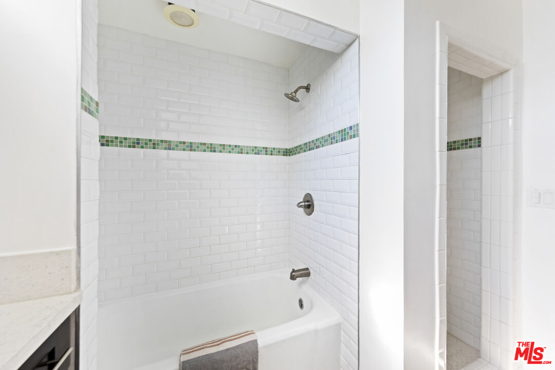 13604 Hart Street Van Nuys, CA 91405 - Photo 30 of 43 a bathroom with a bathtub and a shower