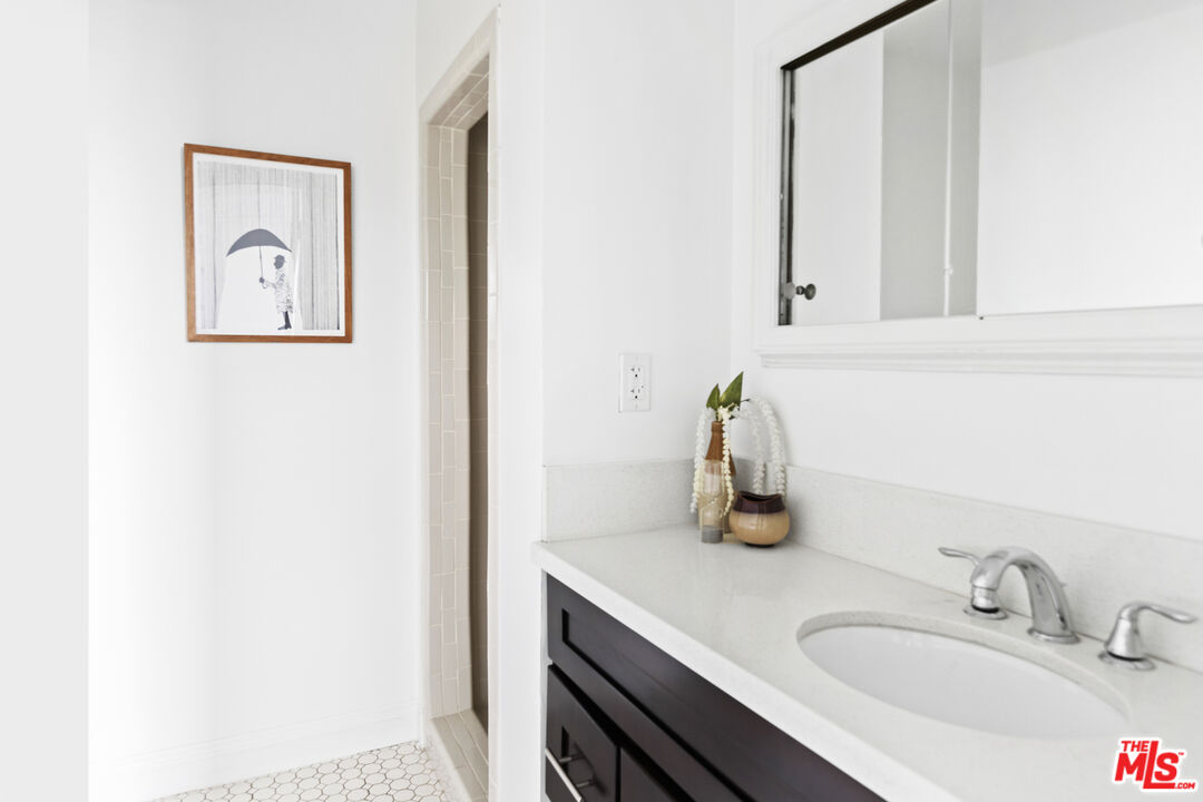 13604 Hart Street Van Nuys, CA 91405 - Photo 33 of 43 a bathroom with a sink and a mirror