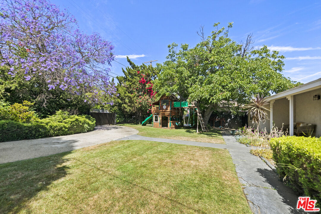 13604 Hart Street Van Nuys, CA 91405 - Photo 4 of 43 a front view of a house with a yard