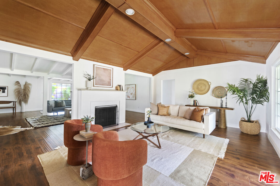 13604 Hart Street Van Nuys, CA 91405 - Photo 5 of 43 a living room with furniture potted plant and a fireplace
