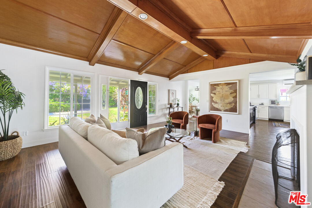 13604 Hart Street Van Nuys, CA 91405 - Photo 8 of 43 a living room with furniture and a floor to ceiling window
