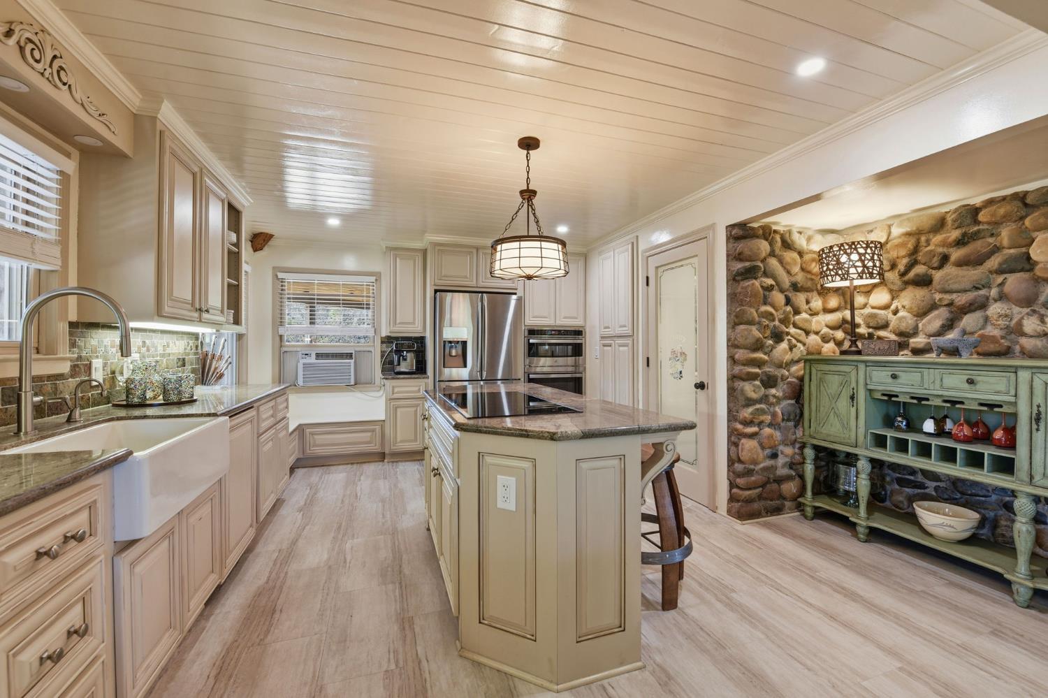 7201 Happy Valley Road Somerset, CA 95684 - Photo 17 of 75 The river rock wall nook in the kitchen adds even more character to the beautiful kitchen space.