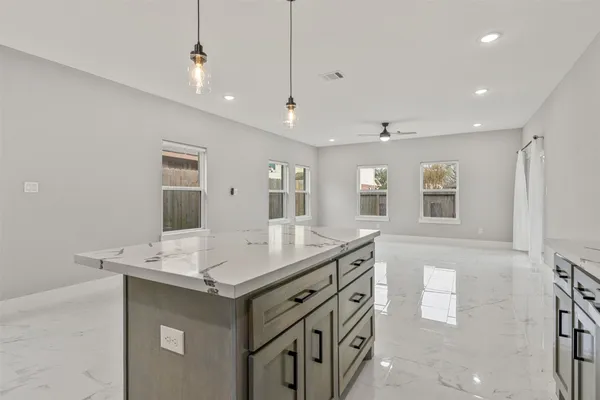a kitchen with stainless steel appliances white cabinets and a stove top oven