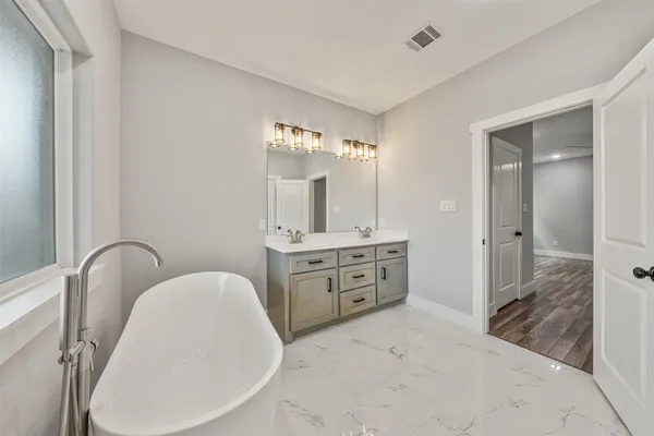 a bathroom with a bathtub and a shower