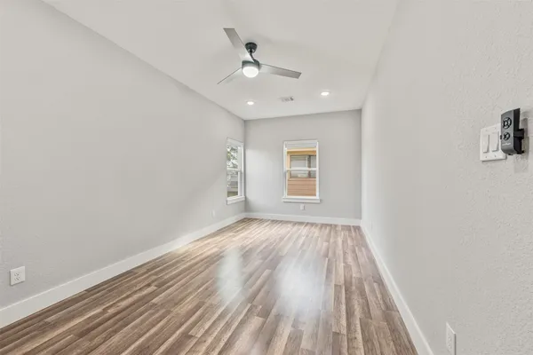 a view of an empty room and wooden floor