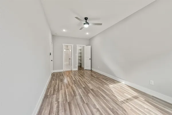 a view of walk in closet with empty racks