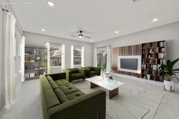 a living room with furniture potted plant and a flat screen tv