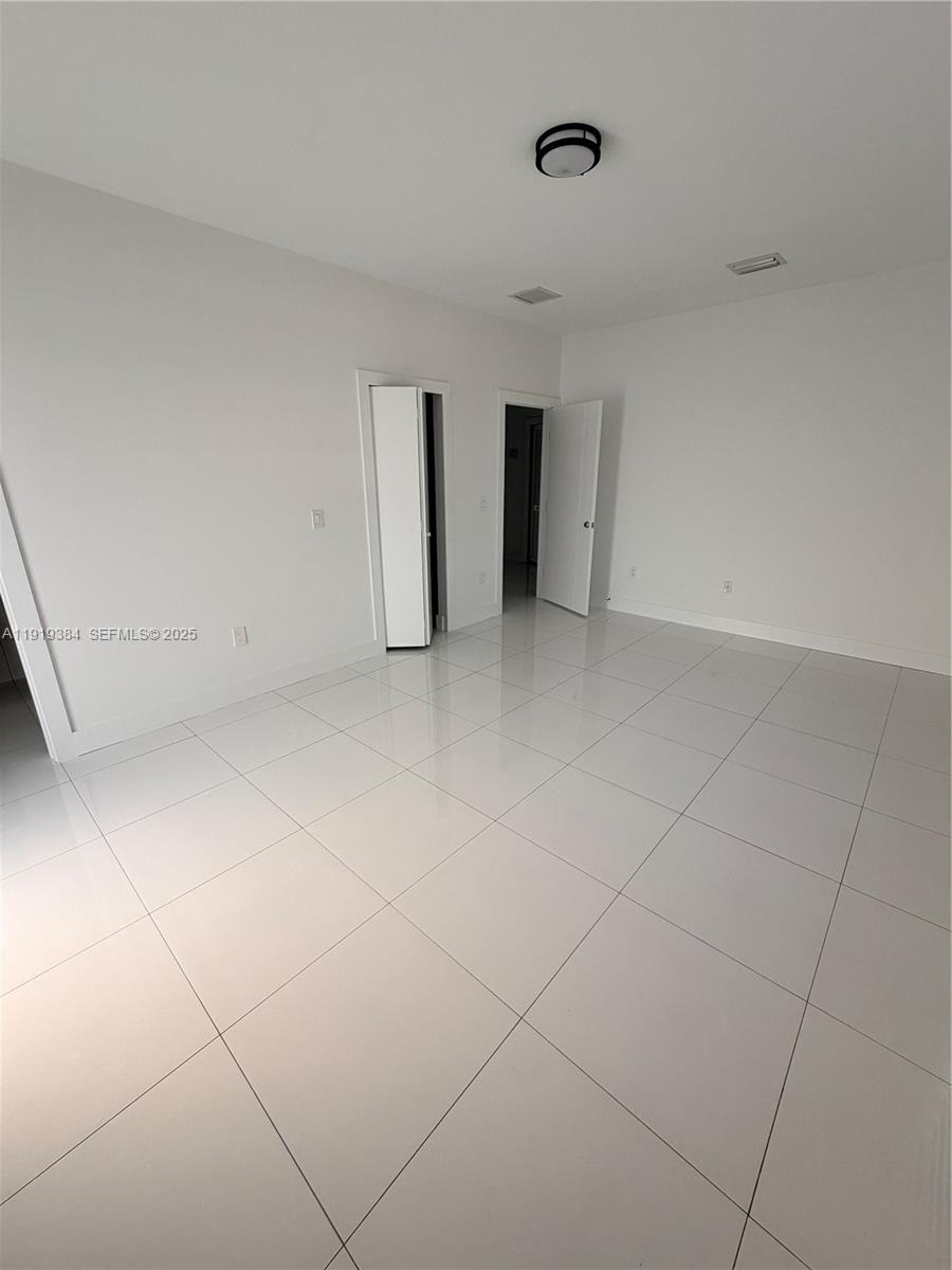 17334 Southwest 303rd Street Homestead, FL 33030 - Photo 13 of 34 a view of an empty room with a window