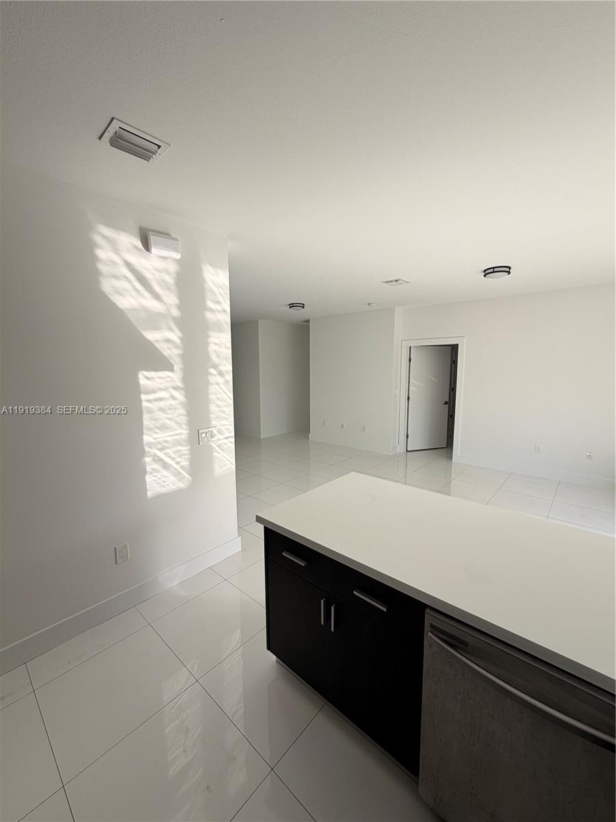 17334 Southwest 303rd Street Homestead, FL 33030 - Photo 20 of 34 a room with a cabinets and chandelier