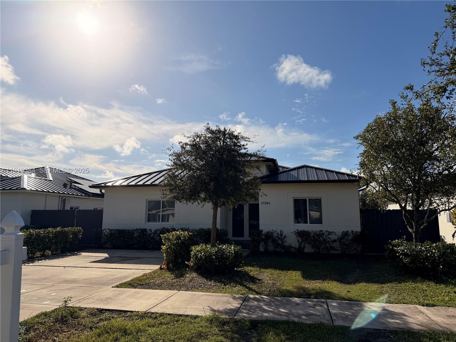 17334 Southwest 303rd Street Homestead, FL 33030 - Photo 2 of 34 a front view of a house with garden and patio
