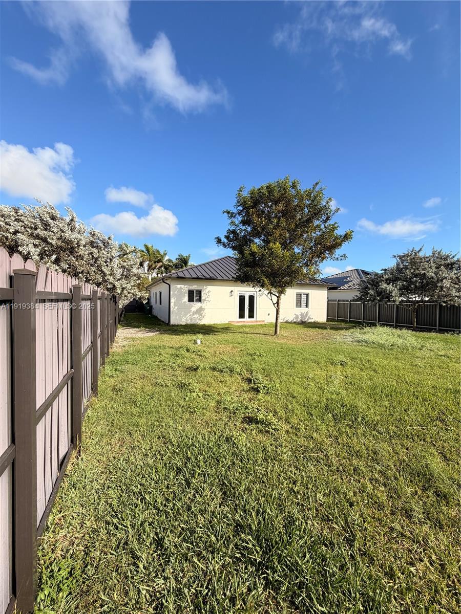 17334 Southwest 303rd Street Homestead, FL 33030 - Photo 31 of 34 a view of a garden with a building in the background