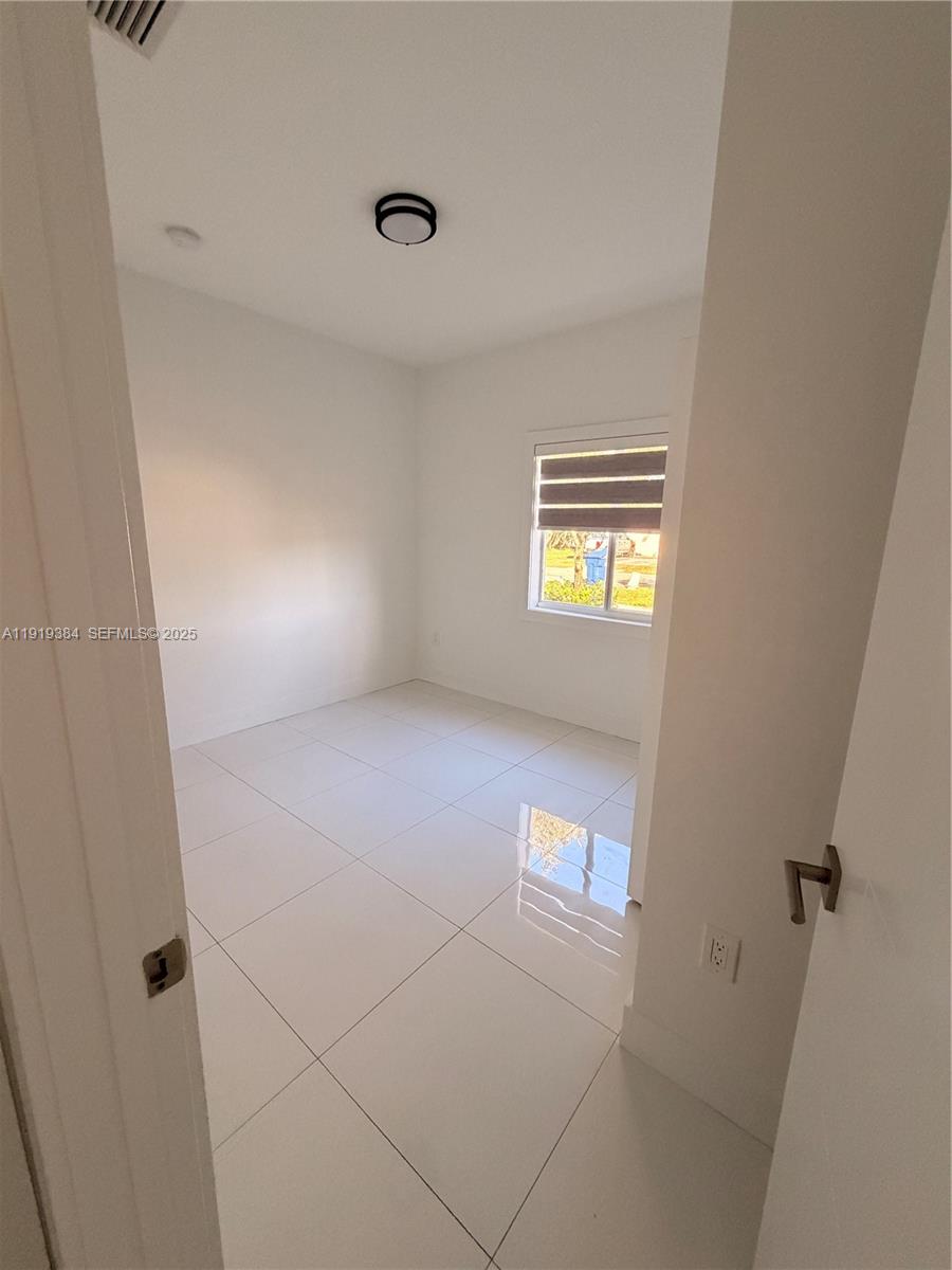 17334 Southwest 303rd Street Homestead, FL 33030 - Photo 7 of 34 a view of an empty room with a window