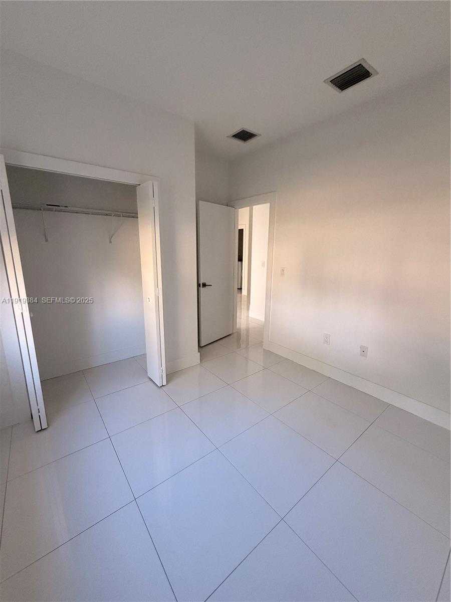 17334 Southwest 303rd Street Homestead, FL 33030 - Photo 8 of 34 a view of a livingroom with an empty space and a window
