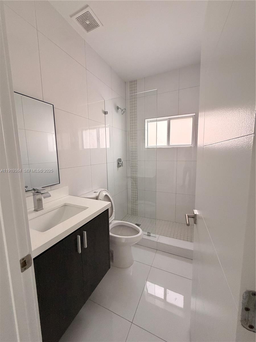 17334 Southwest 303rd Street Homestead, FL 33030 - Photo 9 of 34 a bathroom with a sink a toilet and shower