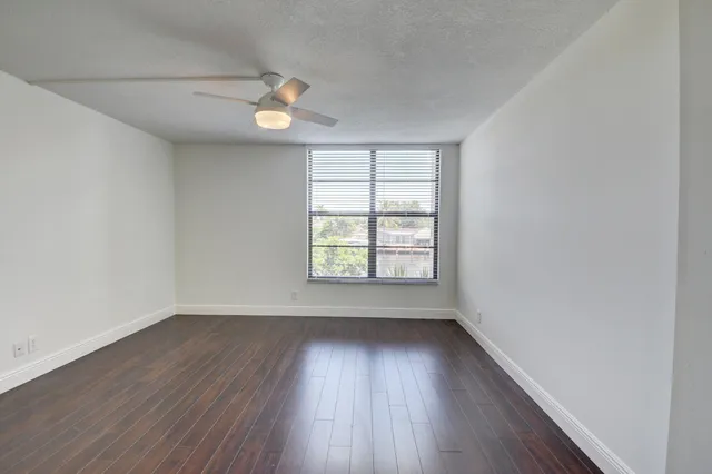 a big room with wooden floor and windows