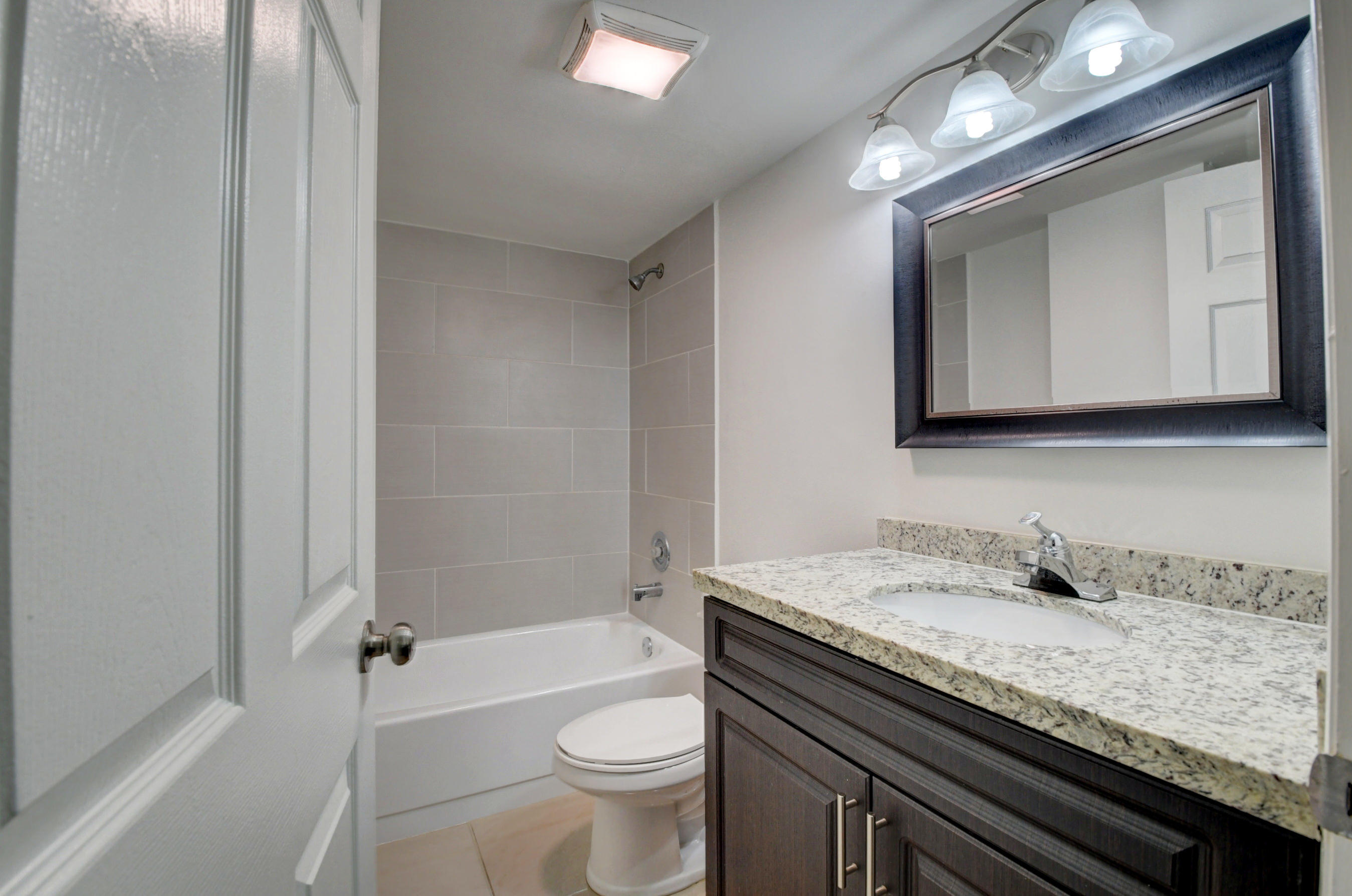 18 Royal Palm Way, Unit 202 Boca Raton, FL 33432 - Photo 27 of 51 a bathroom with a granite countertop bathtub sink mirror vanity and toilet