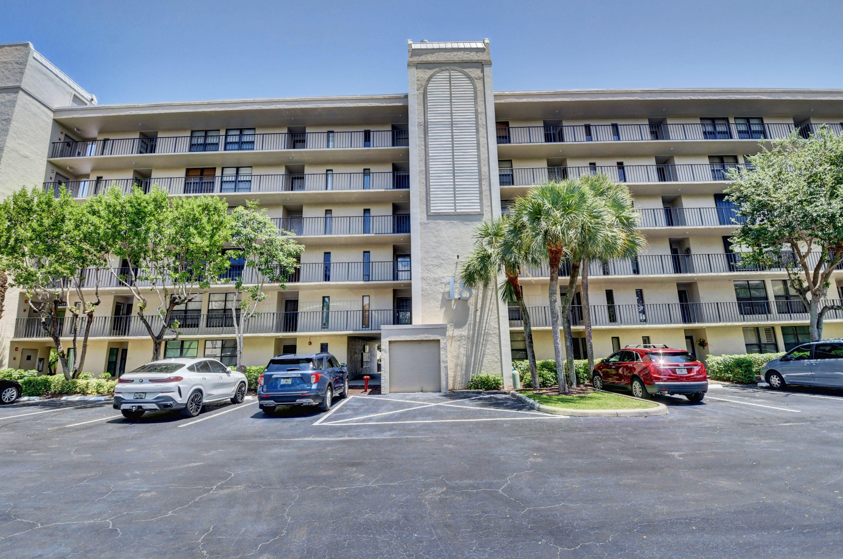 18 Royal Palm Way, Unit 202 Boca Raton, FL 33432 - Photo 28 of 51 a car parked in front of a building