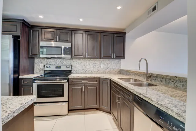a kitchen with a sink stove and refrigerator