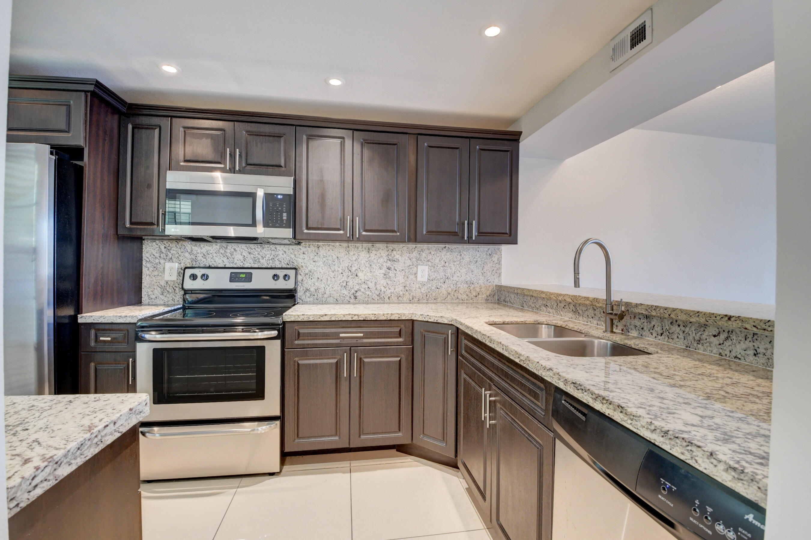 18 Royal Palm Way, Unit 202 Boca Raton, FL 33432 - Photo 5 of 51 a kitchen with stainless steel appliances granite countertop a sink stove and refrigerator
