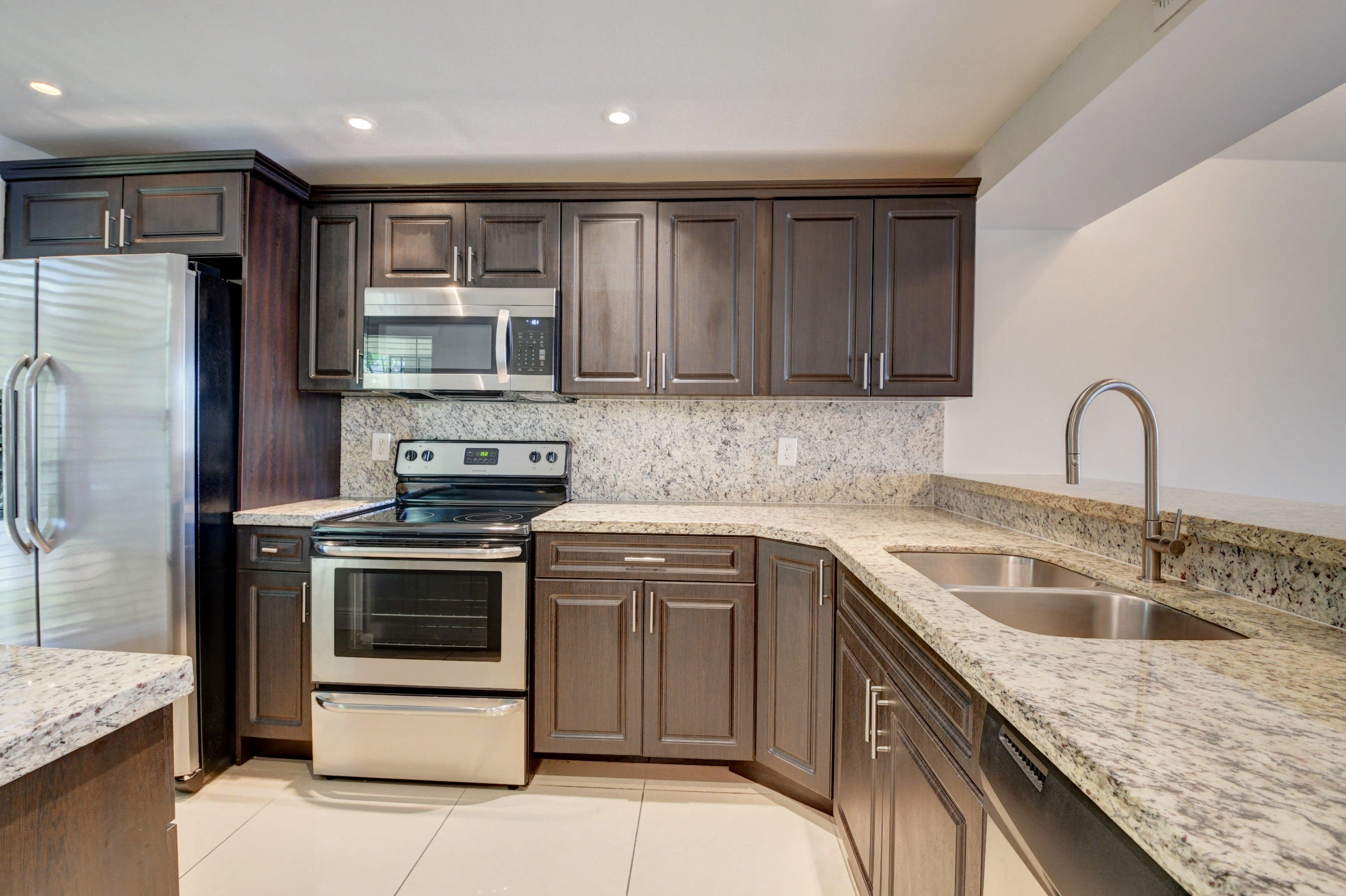 18 Royal Palm Way, Unit 202 Boca Raton, FL 33432 - Photo 6 of 51 a kitchen with a sink stove and refrigerator