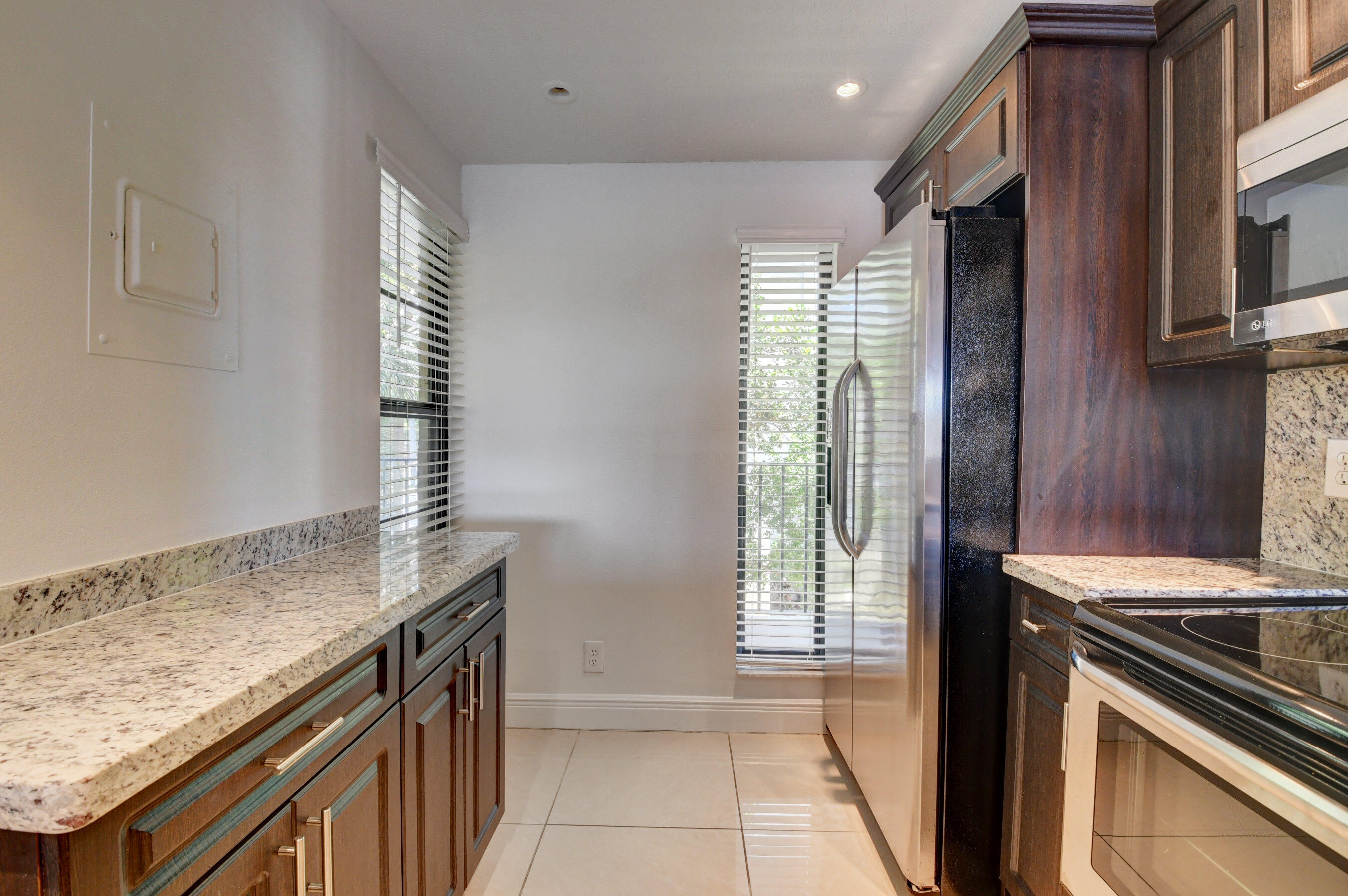18 Royal Palm Way, Unit 202 Boca Raton, FL 33432 - Photo 7 of 51 a kitchen with granite countertop a sink and a stove