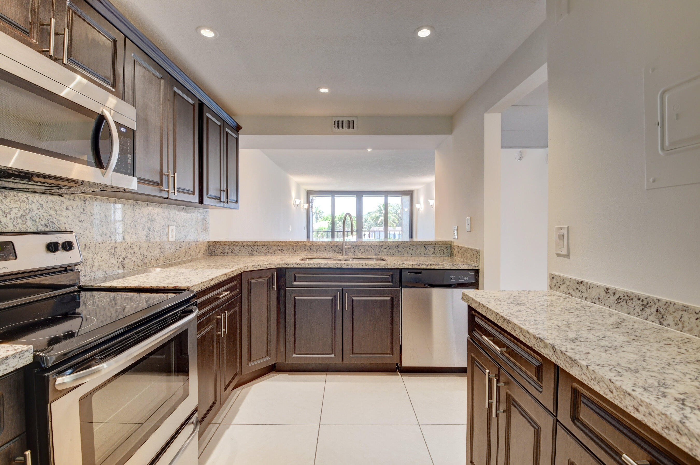 18 Royal Palm Way, Unit 202 Boca Raton, FL 33432 - Photo 8 of 51 a kitchen with stainless steel appliances granite countertop a sink and stove top oven