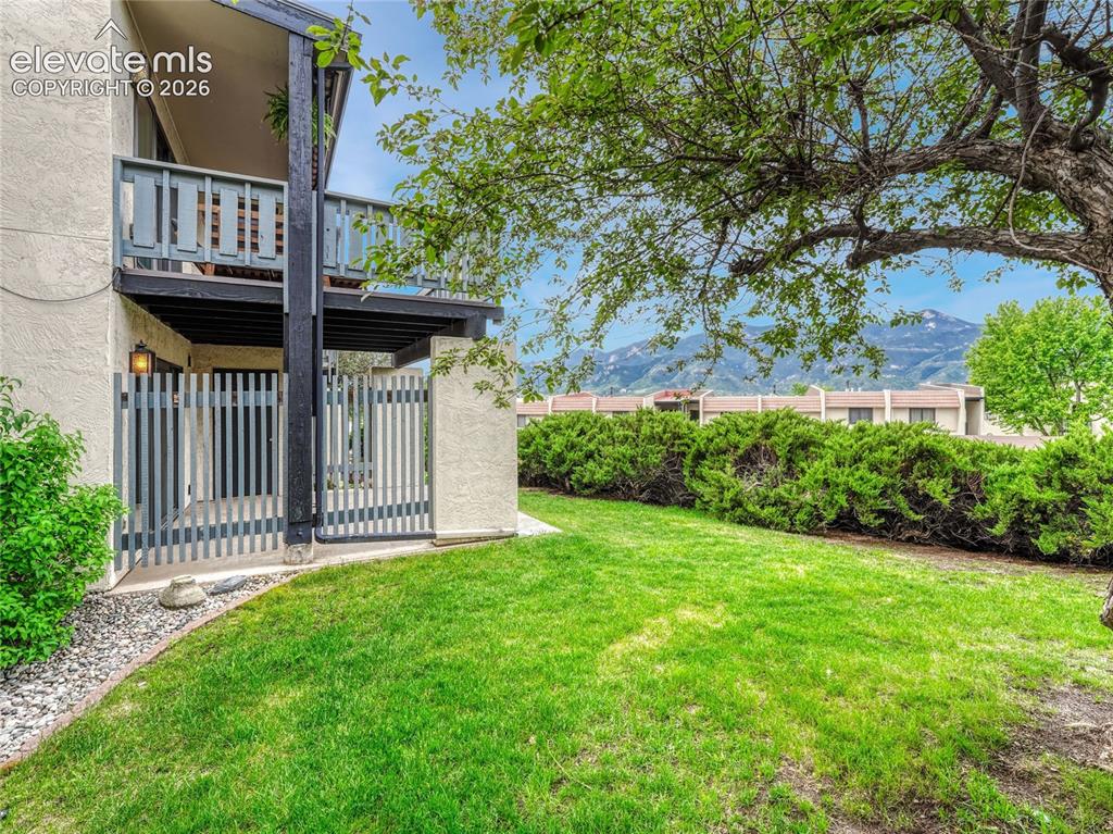 1146 Fontmore Road, Unit A Colorado Springs, CO 80904 - Photo 15 of 24 a view of a house with a small yard and wooden fence