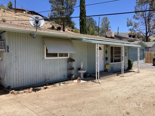 77 Adams Road Wofford Heights, CA 93285 - Photo 2 of 22 a view of a house with a wooden fence
