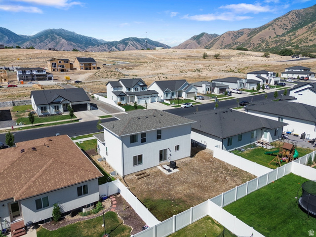 815 West Powderwood Lane Mapleton, UT 84664 - Photo 30 of 34 Expansive backyard space featuring a white privacy fence and a rear patio area