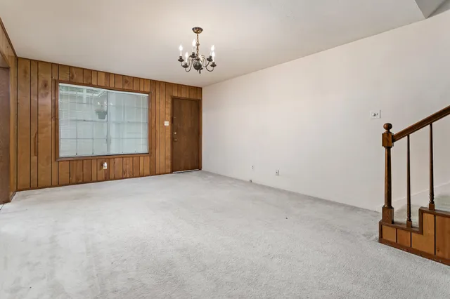 a view of an empty room with a mirror