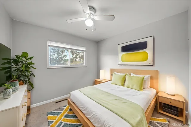 a bedroom with a bed and a potted plant
