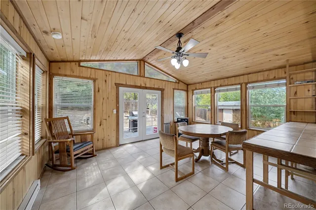 a view of a dining room with furniture large windows and wooden floor