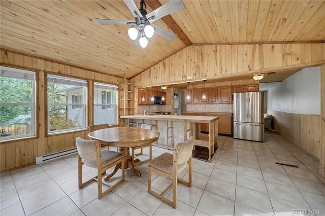 a dining room with furniture and a chandelier