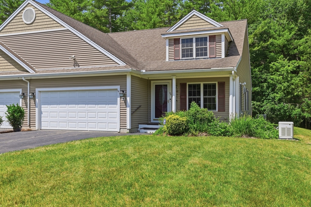 9 Rock Marsh Road, Unit B Wareham, MA 02571 - Photo 2 of 41 a front view of a house with a yard and garage