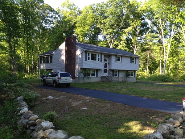 16 Wason Road Hudson, NH 03051 - Photo 1 of 18 a view of a big house with a big yard and large trees