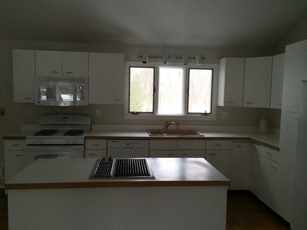16 Wason Road Hudson, NH 03051 - Photo 15 of 18 a kitchen with a sink and cabinets