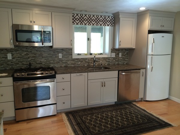 16 Wason Road Hudson, NH 03051 - Photo 7 of 18 a kitchen with granite countertop a sink stove and refrigerator