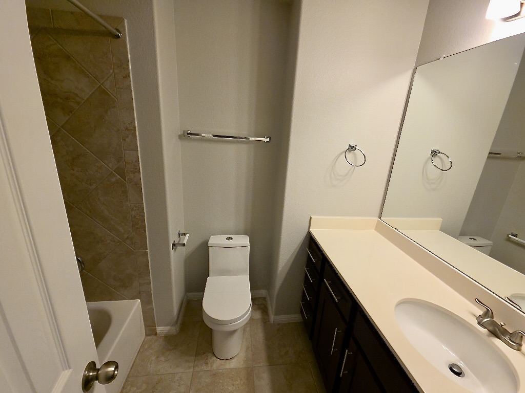 1608 Catalan Road, Unit 302 Austin, TX 78748 - Photo 16 of 21 a bathroom with a sink a toilet and a mirror