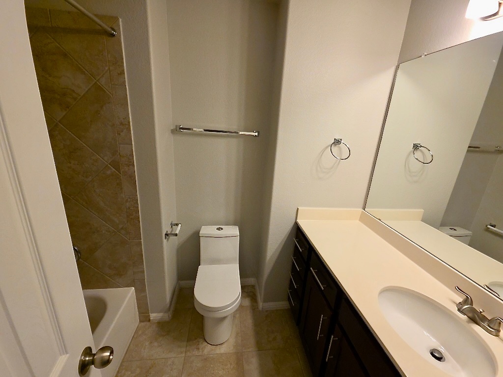 1608 Catalan Road, Unit 302 Austin, TX 78748 - Photo 17 of 21 a bathroom with a sink a toilet and a mirror