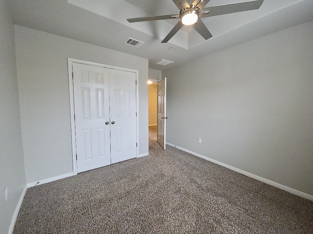 1608 Catalan Road, Unit 302 Austin, TX 78748 - Photo 18 of 21 an empty room with closet and a ceiling fan