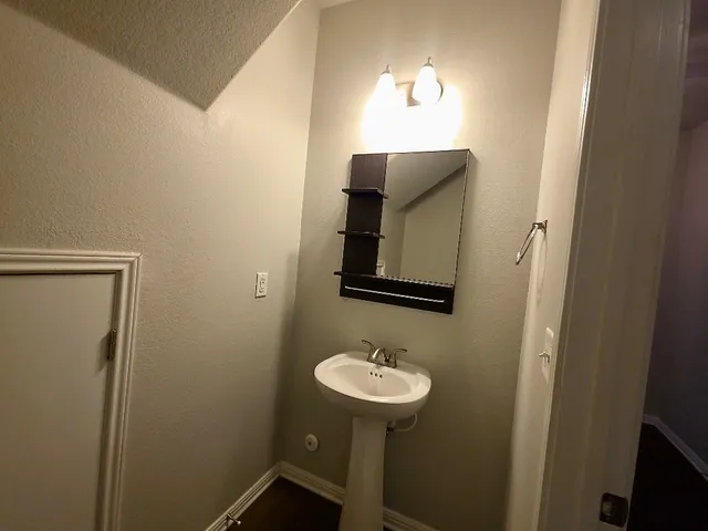 a bathroom with a sink and mirror