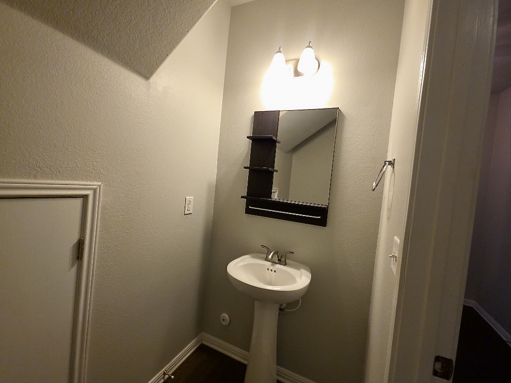 1608 Catalan Road, Unit 302 Austin, TX 78748 - Photo 3 of 21 a bathroom with a toilet sink and mirror