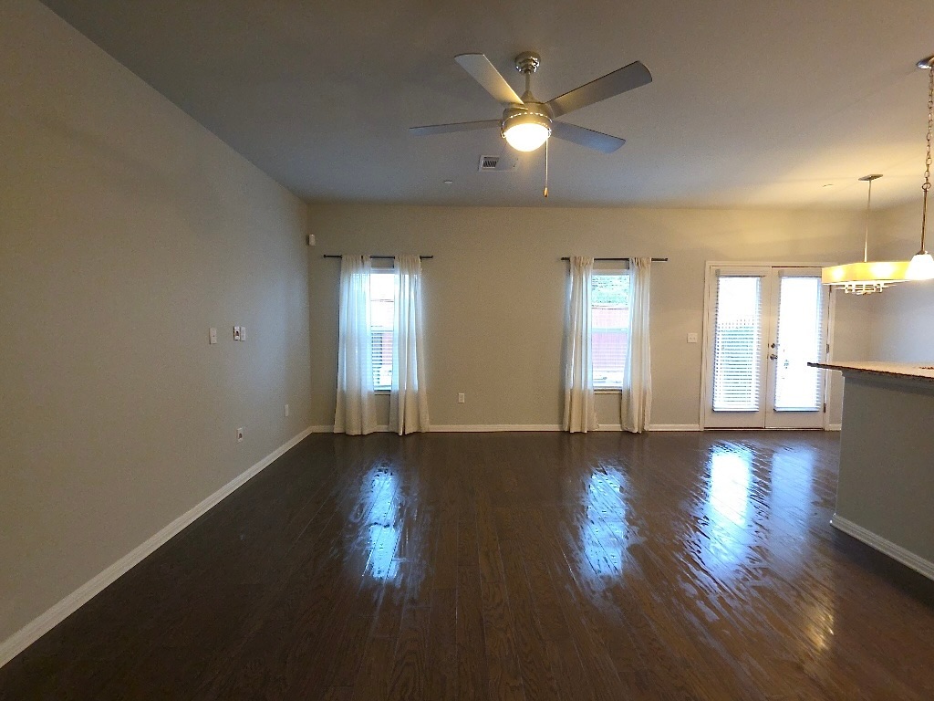 1608 Catalan Road, Unit 302 Austin, TX 78748 - Photo 5 of 21 an empty room with wooden floor and windows